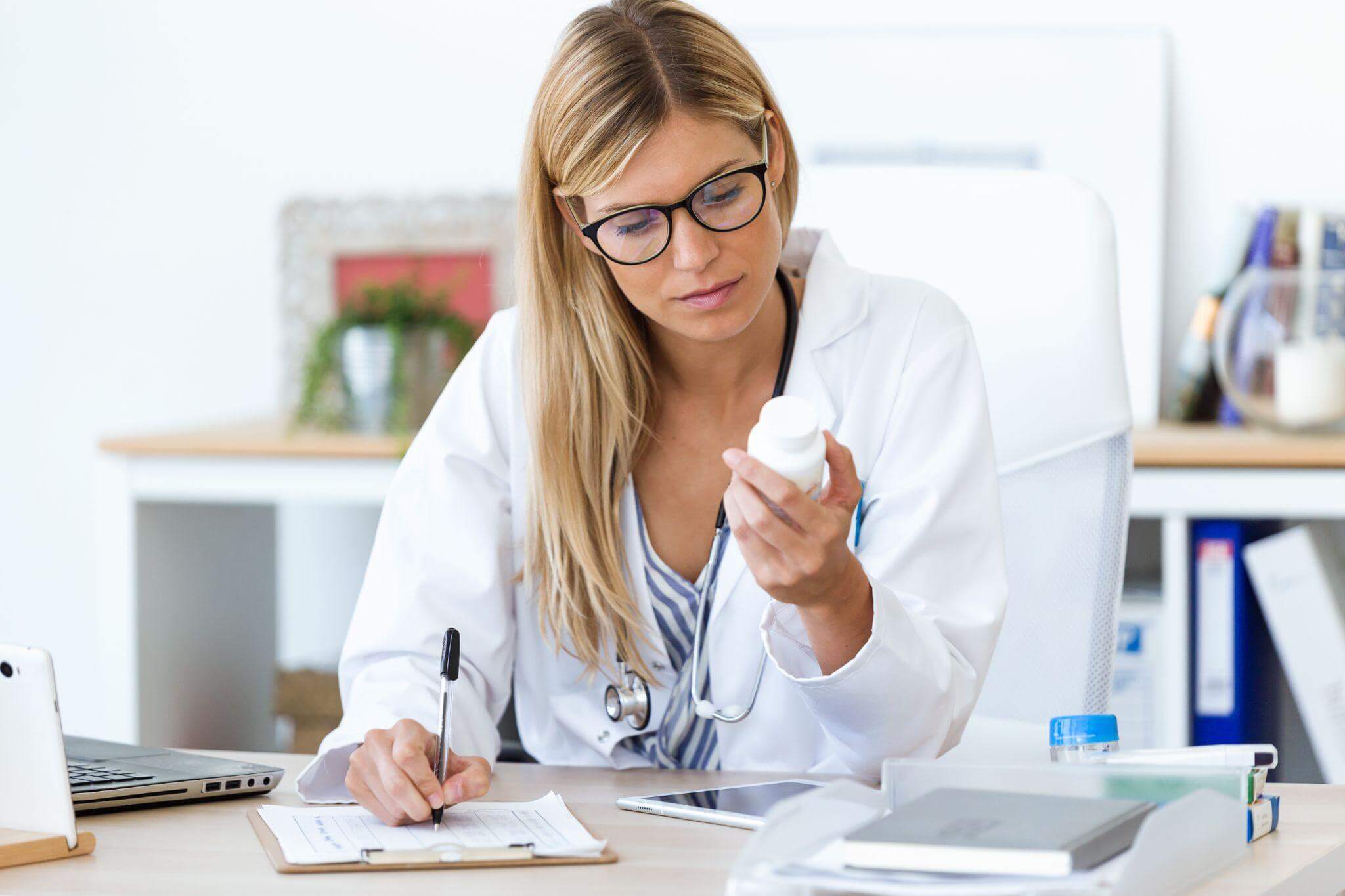 Doctor looking at a pill bottle