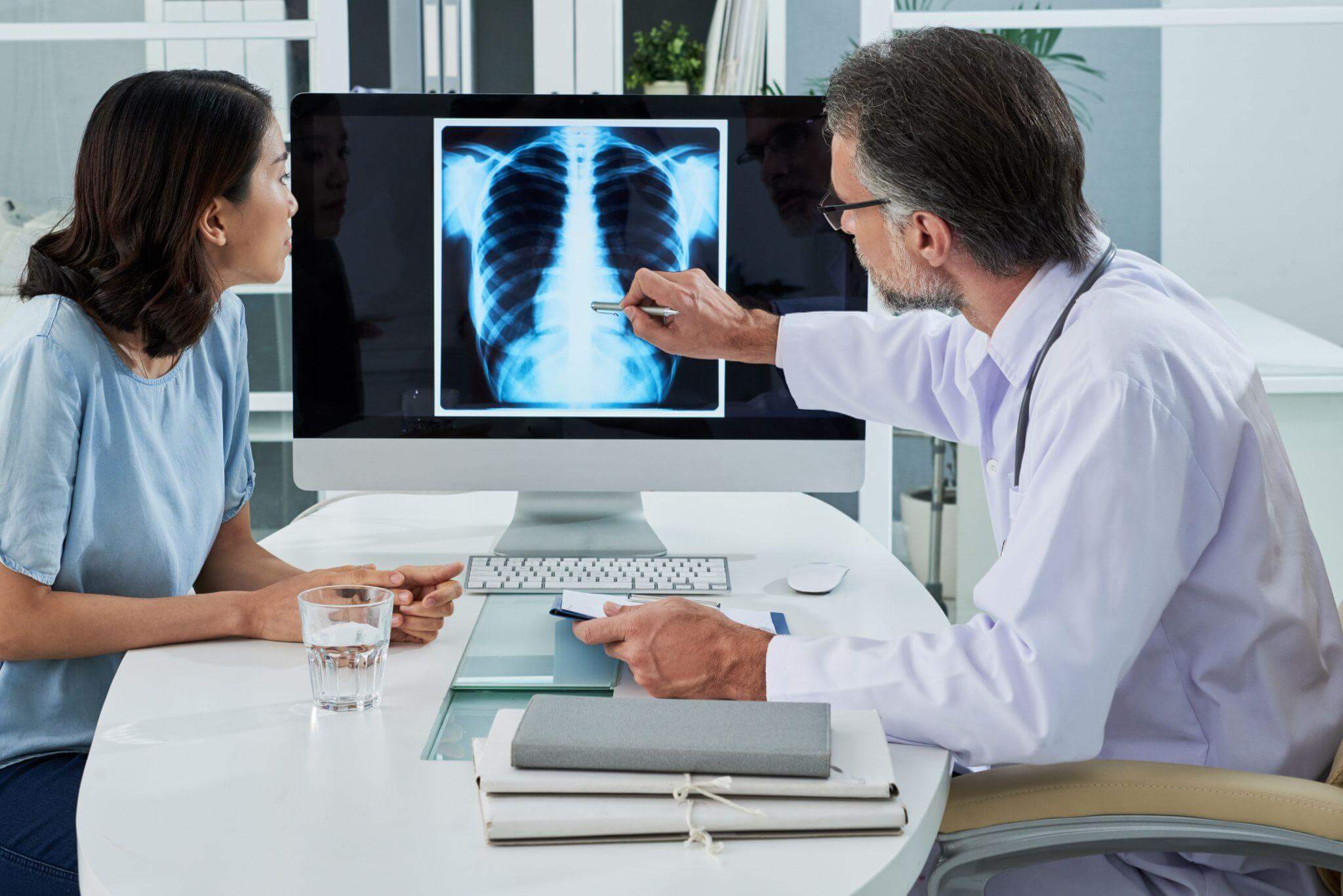 Doctor showing patient a lung x-ray