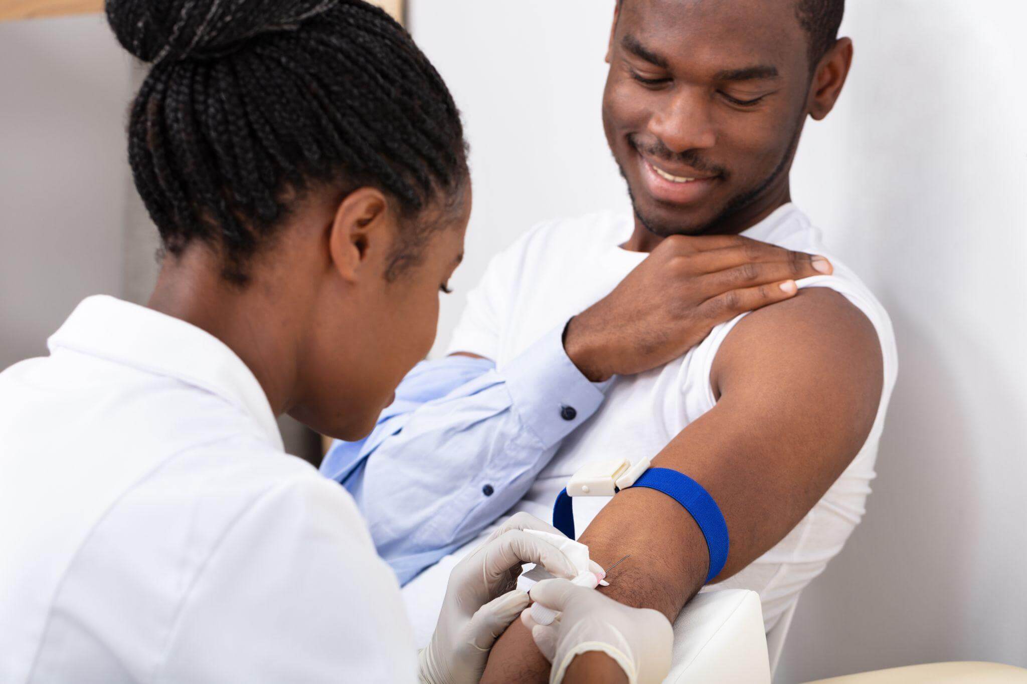 Nurse drawing blood from a young man