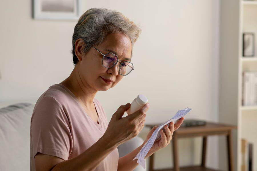 woman holding a bottle of Prednisolone tablets