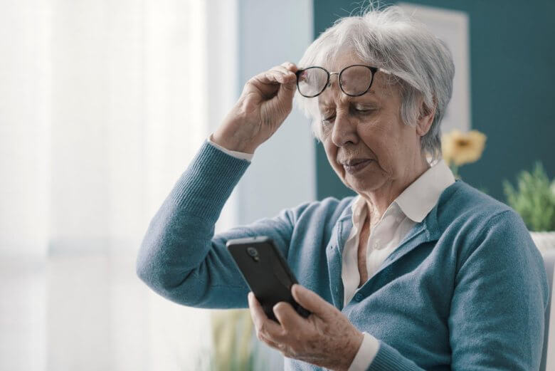 senior lady struggling to read on a phone screen